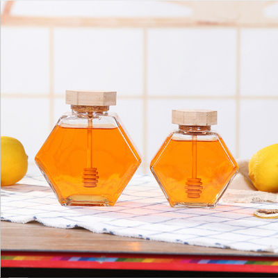Hölzerner Dripper-hitzebeständiges Hexagon-Glas Honey Jar fournisseur